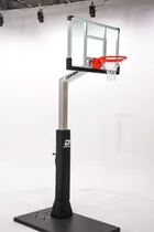 The 54 inch hoop photographed in a studio, standing on a temporary weighted base plate rather than the in-ground anchor it ships with.