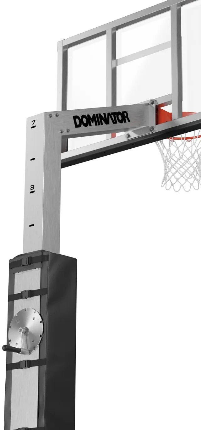 The 60 inch hoop close in on the overhang arm and the top of the pole, showing the Dominator wordmark on the arm and the telescoping joint below it.