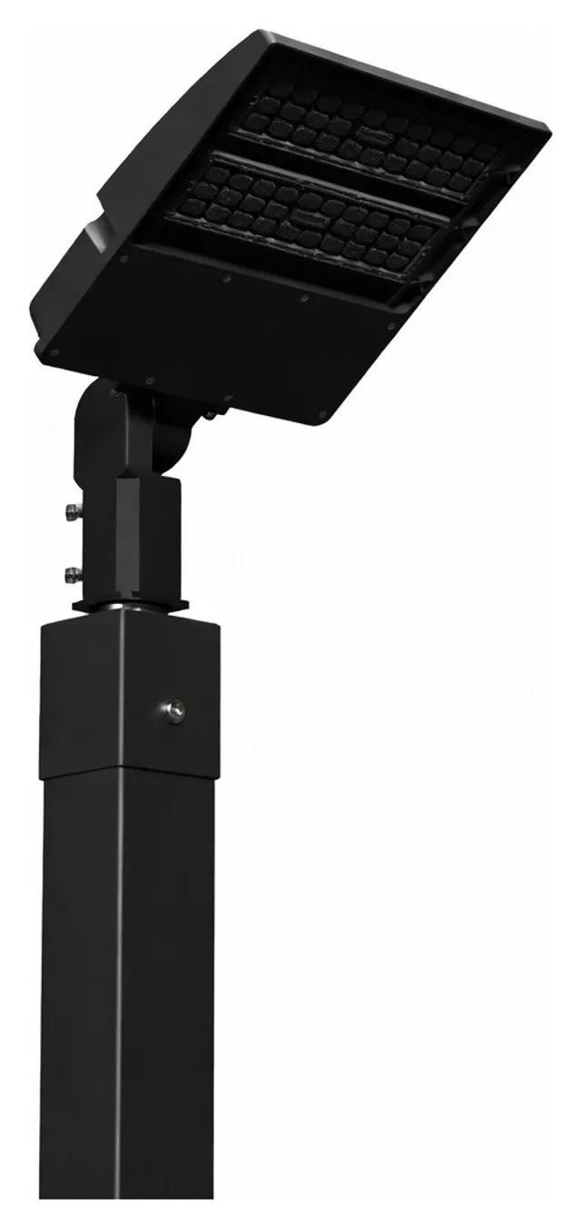 The single head pole in black powder coat, seen from the side with the LED head angled down from its tilt bracket.