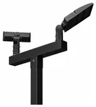 Two black LED heads on a black crossbar, one turned toward the camera and one away, on a black square pole.