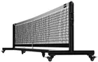 The Pro portable net in black powder coat, seen at an angle across its full width, with the winder handle on the near post and locking casters under both feet.