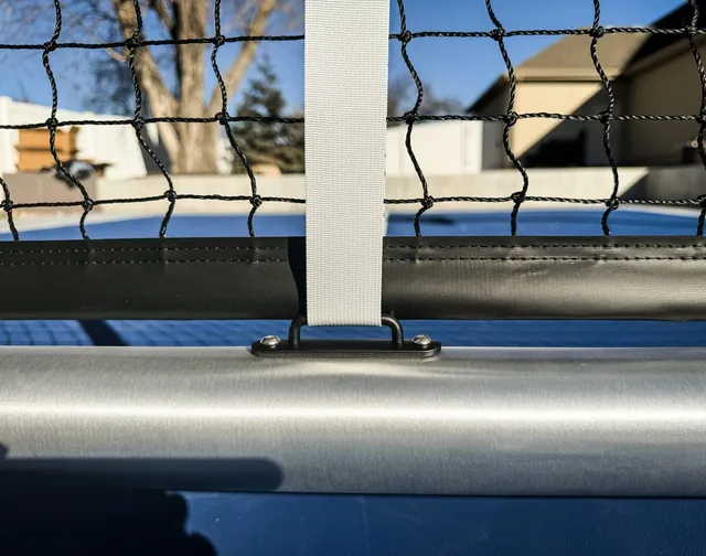 Close on the centre of the Pro net, where the white centre strap runs down from the tape to the frame.