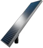 Close on the solar panel of a single head pole, the cells angled up off the bracket with the fixture underneath.