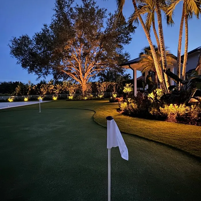 Putting green with flagstick lit at night